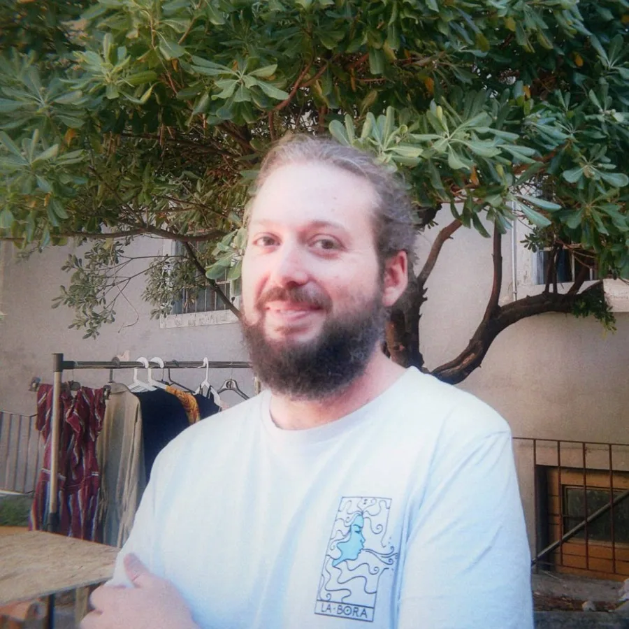 Portrait of Matteo Nurisso smiling in front of a tree